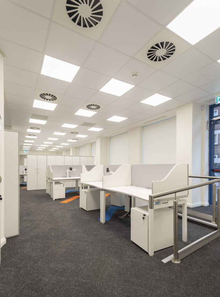 This project involved the renovation of the ground floor from open plan meeting spaces to an open plan office. It includes a number of private spaces and a large boardroom that is divided with a combination of acoustic and glazed partitions. In order to extend the open plan area, we filled in the existing stairwell to a basement with concrete. Originally, there was a commercial kitchen toilet changing room and store in the basement. We demolished all partitions and removed all floor and wall partitions. We then refitted new partitions. This included a canteen, two meeting rooms, male/female toilets, shower and changing rooms, store area, new ducting for heat recovery units, and passive fire duct fitted for the lobby area.  We also completed all floor and wall finishes. Externally, we removed the façade and installed a new one. Following this, we fitted an entrance to suit the new ground floor layout. We also fitted a new emergency door leading to a laneway and removed and replaced an old bar door with a new window to match.